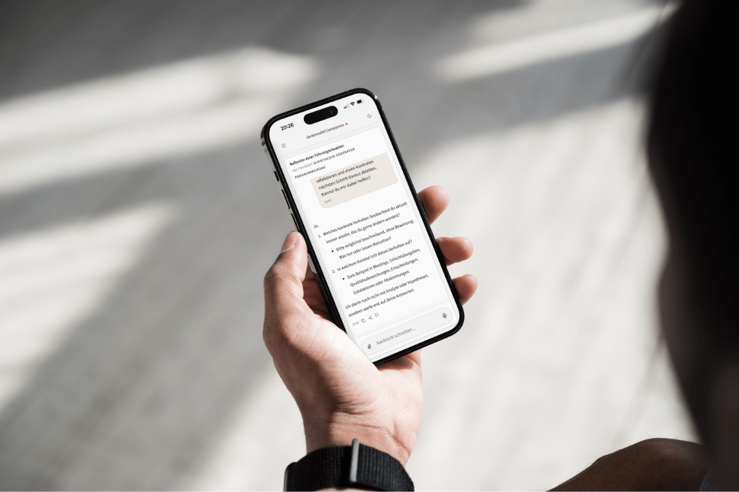 Eine Führungskraft nutzt den denkmodell Companion auf dem Smartphone zur Reflexion einer Praxissituation.